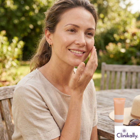 Woman applying tinted sunscreen outdoors for natural sun protection