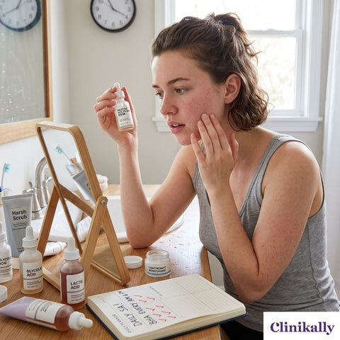 Woman examining dry skin while holding salicylic acid serum