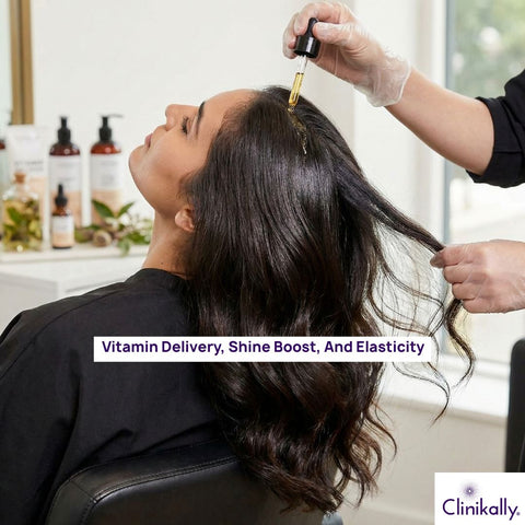 Woman using hair serum on shiny hair
