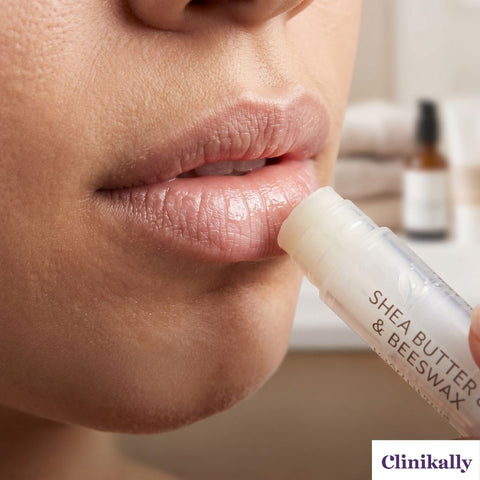 Close-up of lip balm moisturizing dry lips