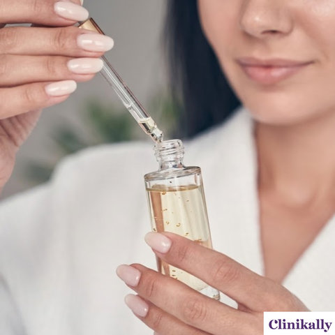 A woman holding a clear glass dropper bottle