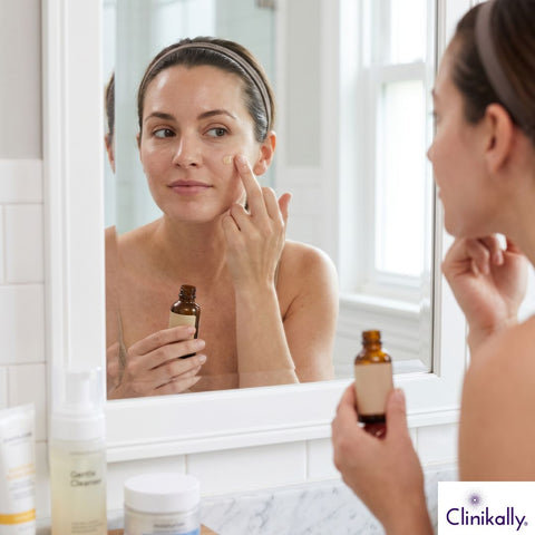 Woman applying retinol serum on combination skin