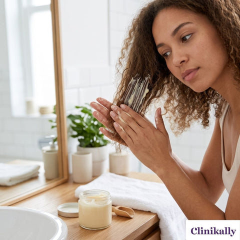 Woman applying hair mask to frizzy hair