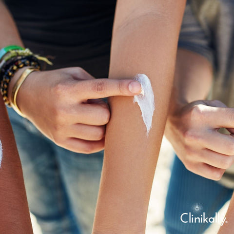 Applying shea butter cream to the arm