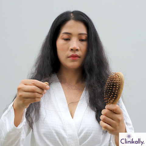 Women combing hair and experiencing hair loss