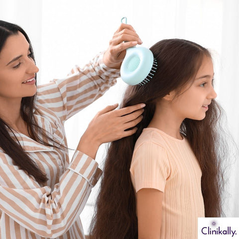 Mother brushing child’s long hair gently