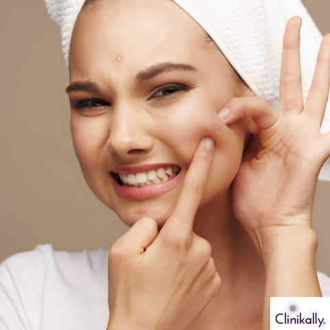 Woman squeezing painful nasal pimples
